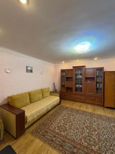 a living room with a couch and a rug at Квартира подобово in Vinnytsya