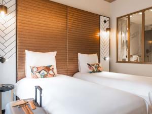 Ένα ή περισσότερα κρεβάτια σε δωμάτιο στο Mercure Luxembourg Off Kirchberg