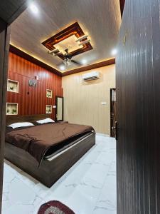 a bedroom with a large bed and wooden walls at Sky Rooms & Cafe in Mughal Sarāi