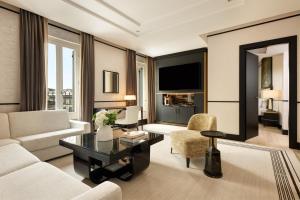 a living room with a couch and a table at Nobu Hotel Roma in Rome