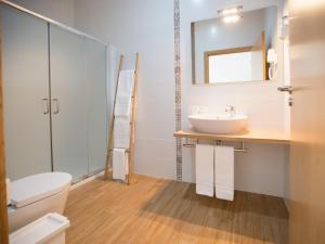 a bathroom with a sink and a toilet and a mirror at Tavira Monte in Tavira