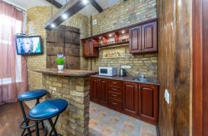 a kitchen with a counter and stools in a room at Baroque-Style Apartment in the Heart of Kyiv in Kyiv