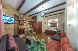 a large living room with a couch and a kitchen at Baroque-Style Apartment in the Heart of Kyiv in Kyiv