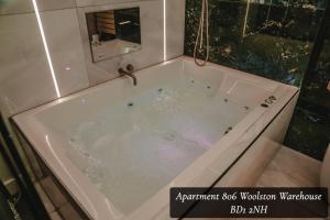 a bath tub filled with water in a bathroom at The Opulence in Bradford