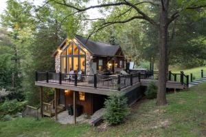 a house with a wrap around porch and a wrap around deck at Pet-Friendly Delta Cabin with Private Hot Tub! in Delta