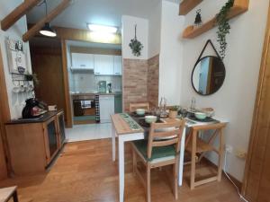 a kitchen and dining room with a table and a mirror at Mira Moleta bienvenidos a Canfranc in Canfranc-Estación +28 photos