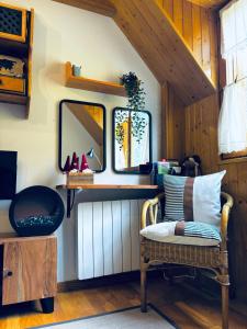 a room with a chair and a mirror at Mira Moleta bienvenidos a Canfranc in Canfranc-Estación