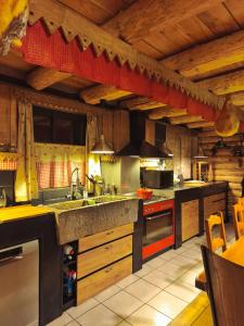 a kitchen with wooden ceilings and a large kitchen with counters at Maison de charme à la Salvetat-sur-Agout 3 chambres in La Salvetat