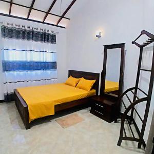 a bedroom with a bed with a mirror and a ladder at Solara Holiday Homes in Anuradhapura