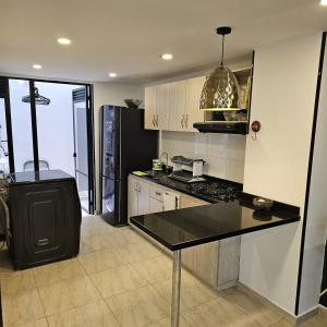 a kitchen with a black counter top in a room at Restrepo 201 in Bogotá