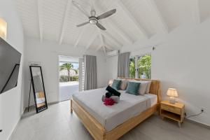 a bedroom with a bed with a teddy bear on it at Villa Flair in Jan Thiel