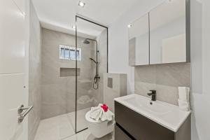 a bathroom with a toilet and a sink and a shower at Villa Flair in Jan Thiel