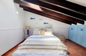 a bedroom with a large bed with blue cabinets at Villa Blue beach Tabarca in Tabarca