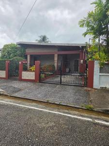 a house with a red fence in front of it at Praise Health Services in Valencia Village