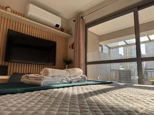 ein Schlafzimmer mit einem Bett und einem Flachbildfernseher in der Unterkunft Flat em Moema Grand Vitrali - Aero Congonhas in São Paulo + 27 Fotos
