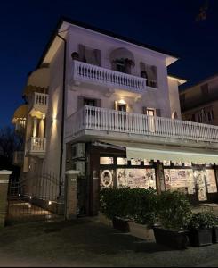 a large white building with a balcony on top of it at Lodge 46 Luxury Apartment in Venice