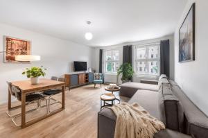 a living room with a couch and a table at Lofty Torstr Apartments, 4 unique units from 1-3 bedrooms in Mitte, ideal for families & groups, from 2 up to 8 Guests in Berlin