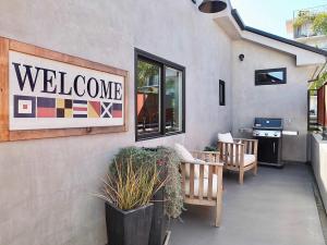 a welcome sign on the side of a building at Naples Luxury Retreat - 2 BDR Walk to Beach Dining & Shops in Naples