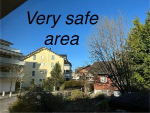 a sign that says very safe area in a city at KARL Apartment in Interlaken