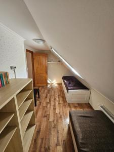 a room with a staircase with a bed underneath it at Lagom Apartman in Gyula