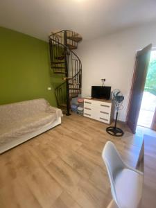 una sala de estar con una escalera de caracol y una silla en White Moon, en Fontane Bianche 13 fotos más