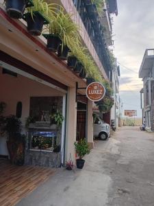a store with a sign on the side of a building at Villa Luxez in Kalmunaikudiyiruppu