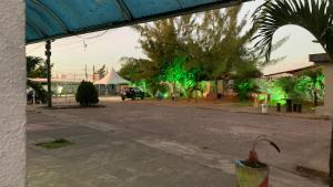 an empty street with green lights in the distance at Thomás more 1 Flat in Santa Rita