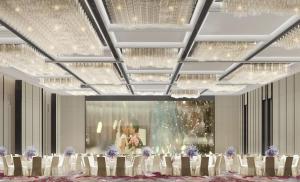 a rendering of a banquet hall with white tables and chandeliers at Crowne Plaza Weihai Binhai by IHG in Weihai +40 photos