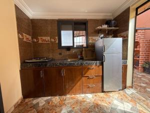 a kitchen with a sink and a refrigerator at Casa del sol Sidi Ifni in Sidi Ifni +14 photos