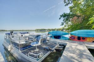 a boat is docked at a dock on the water at Big Fish Bay Hideaway - Rice Lake Home with Dock! in Rice Lake