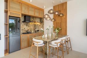 a kitchen with a marble table and stools at Ardhana 9 - Modern Villa in Ungasan - Pool - Wi-Fi - Daily Cleaning in Ungasan