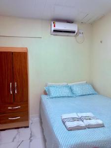 a bedroom with a bed with a dresser and a heater at FLAT -Apartamento na Pedreira Belém in Belém