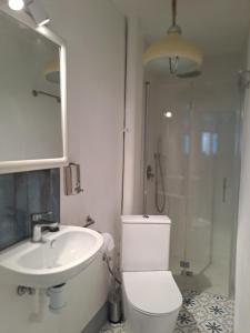 a bathroom with a toilet and a sink and a shower at El Cap de Pedra in Calles +21 photos
