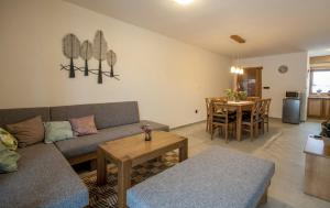 a living room with a couch and a table at Podhradkom in Závažná Poruba +18 photos