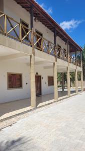 an outside view of a building with a balcony at Casa da Bênção - Praia de Moitas in Amontada