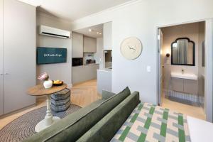 a living room with a couch and a table at Charles Hope Cape Town in Cape Town