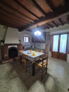 a living room with a table and a fireplace at La Corte del Tadde in Lammari