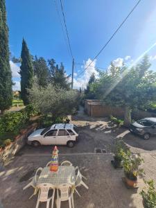 a patio with a table and chairs and a car at La Corte del Tadde in Lammari