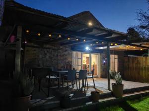 a patio with a table and chairs under a pergola at Sielerus by Horeb Clarens in Clarens