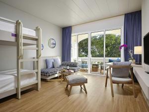 a bedroom with a bunk bed and a living room at Mercure Vung Tau Resort in Vung Tau +122 photos