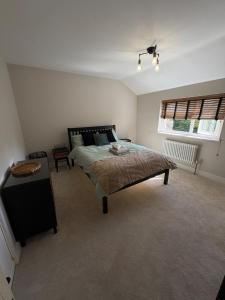 a bedroom with a large bed and a window at Picturesque Naval Cottage with incredible views in Portsmouth