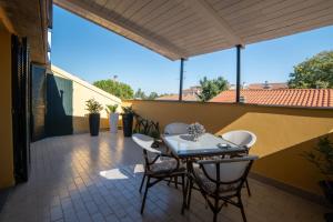 a patio with a table and chairs on a balcony at La Coccola by Andrea in Castelfranco Emilia