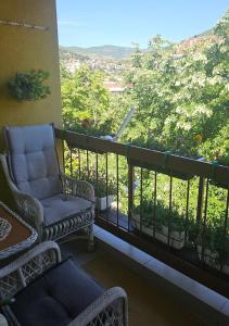 a balcony with chairs and a view of the mountains at Apartman Trebinje sa parkingom in Trebinje +10 photos
