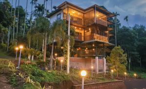 a house in the woods at night with street lights at GreensVista Pool Wayanad AC Pillar Homestay near Natural Stream and Amazing View in Panamaram