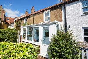 an extension to a house with a white door at Tern Cottage in Wells next the Sea