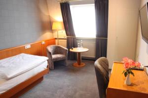 Ένα ή περισσότερα κρεβάτια σε δωμάτιο στο Hotel Kloppenborg