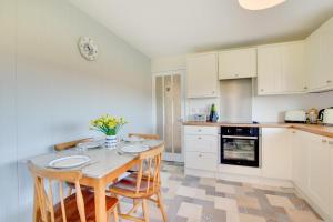 a kitchen with a table and chairs in a kitchen at Bolams Lodge in Ancroft