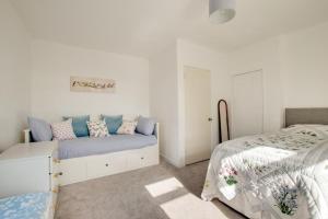a white bedroom with a bed and a white bedskirts at Bolams Lodge in Ancroft