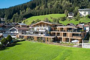 a resort in the middle of a green field at Hotel Garni Pinzgau, Relax & Lifestyle in Neukirchen am Großvenediger +75 photos