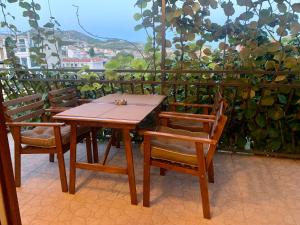 a wooden table and chairs sitting on a balcony at Apartments Beata in Marina